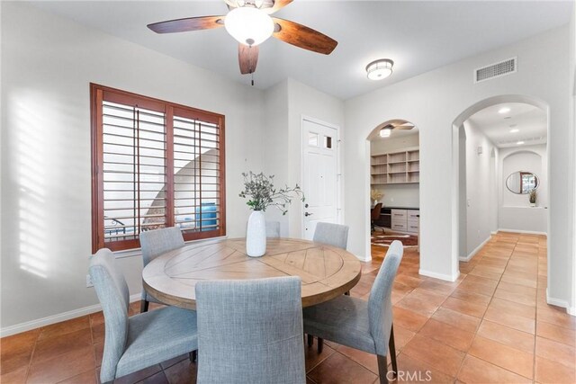 dining area with ceiling fan and light tile patterned flooring