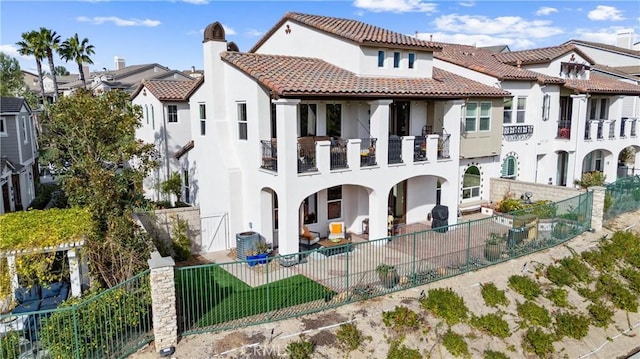 rear view of property featuring a balcony