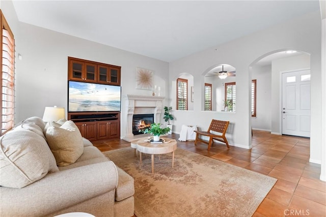 living room with ceiling fan and light tile patterned floors