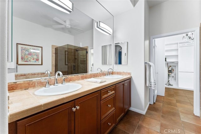 bathroom with ceiling fan, vanity, tile patterned flooring, and a shower with shower door