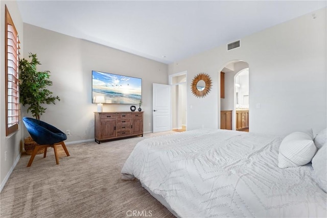 carpeted bedroom with connected bathroom