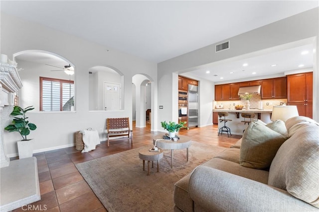 tiled living room featuring ceiling fan