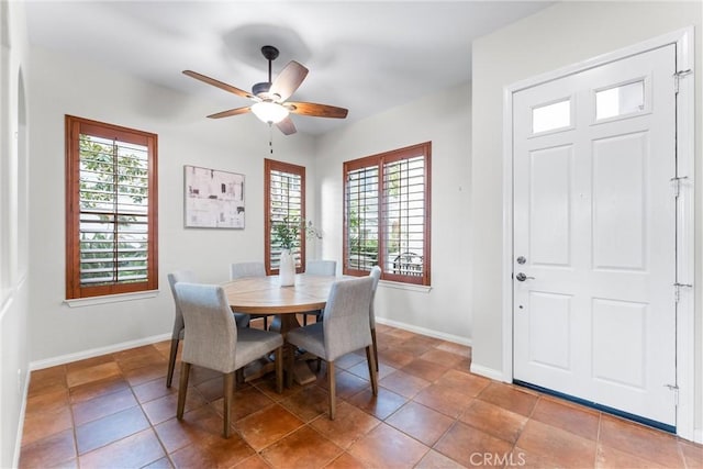 tiled dining area with ceiling fan