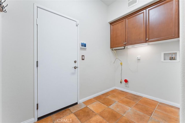 washroom featuring light tile patterned floors, washer hookup, gas dryer hookup, and cabinets