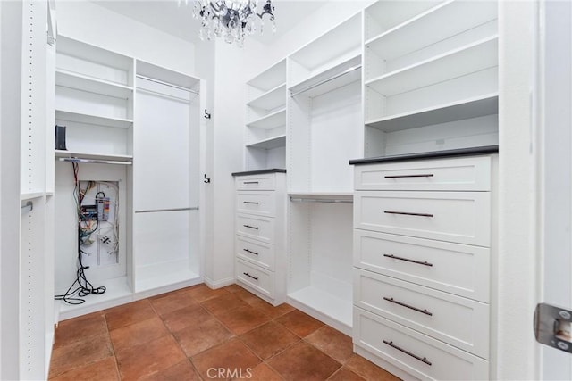 spacious closet with a notable chandelier