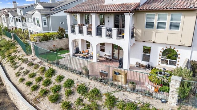 back of property featuring a balcony and a patio