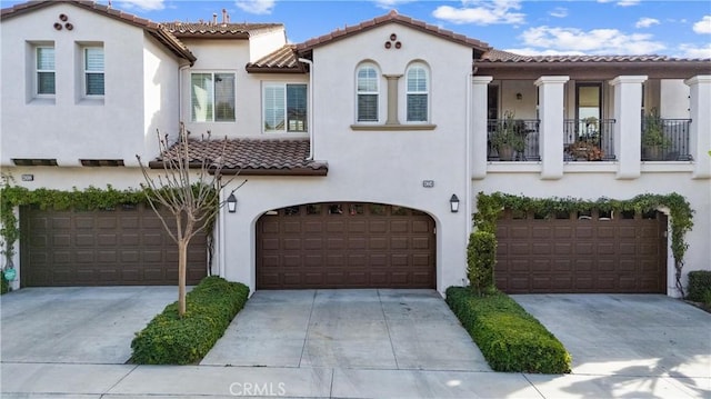 mediterranean / spanish-style house with a garage