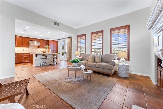 living room featuring a wealth of natural light and light tile patterned flooring