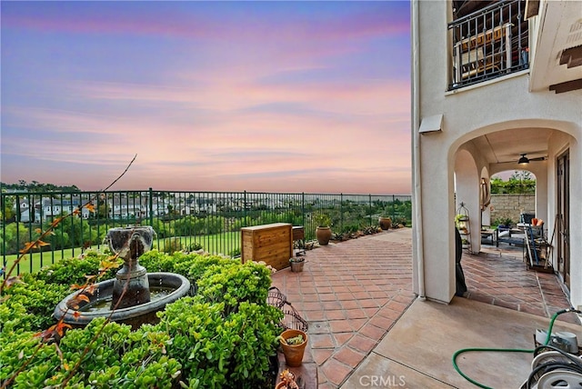 view of patio terrace at dusk