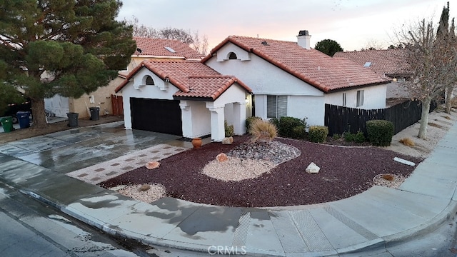 mediterranean / spanish house featuring a garage