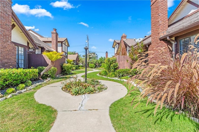 view of property's community featuring a lawn