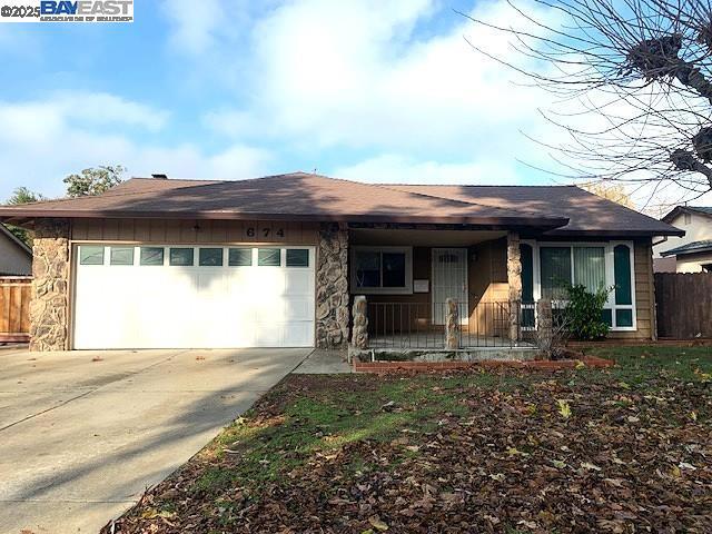 single story home with a garage and covered porch