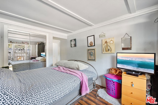 bedroom featuring dark hardwood / wood-style floors, beamed ceiling, and ornamental molding