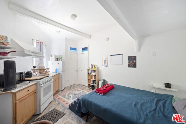 bedroom with light wood-type flooring and beam ceiling