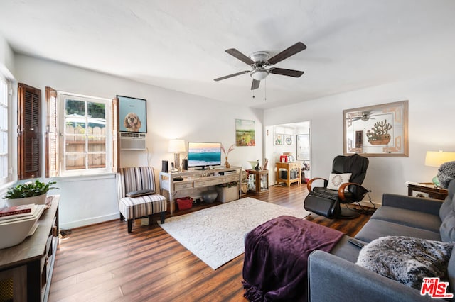 living room featuring ceiling fan and dark hardwood / wood-style flooring