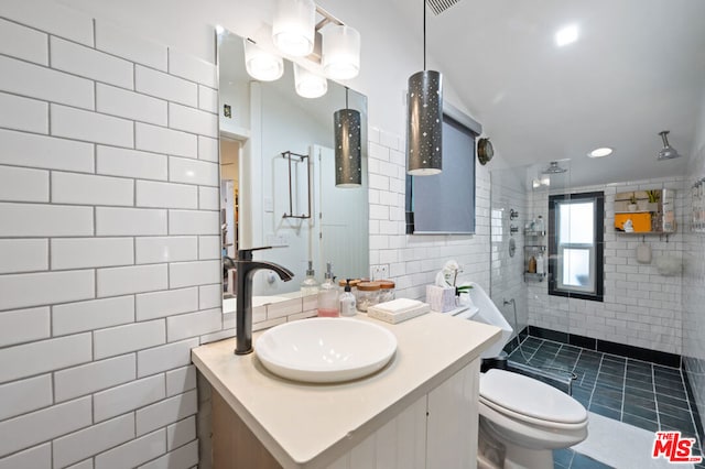 bathroom with an enclosed shower, vanity, tile walls, and toilet