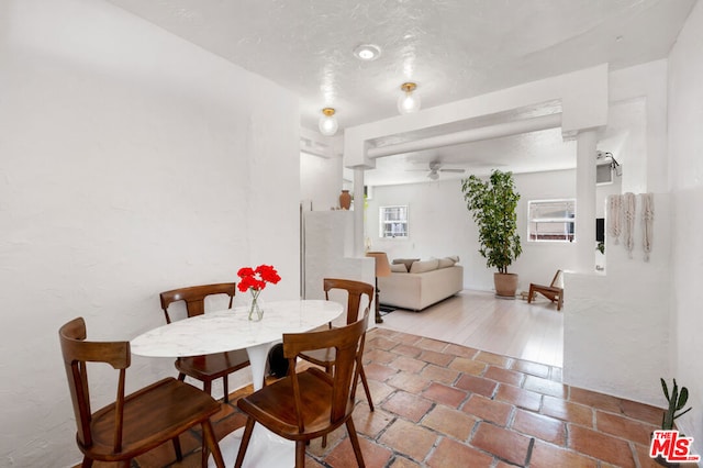 tiled dining area with ceiling fan