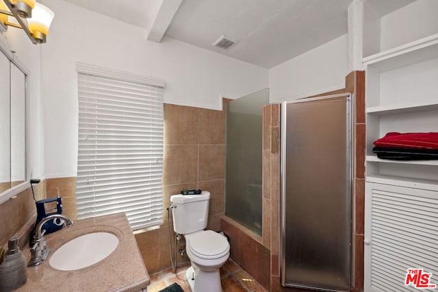 bathroom with a shower with shower door, vanity, beam ceiling, and toilet