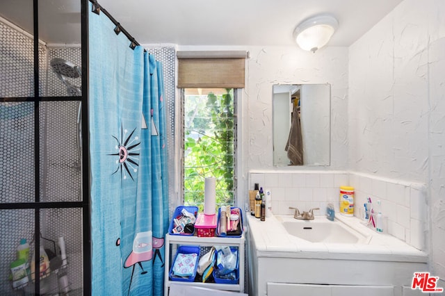 bathroom with walk in shower and vanity