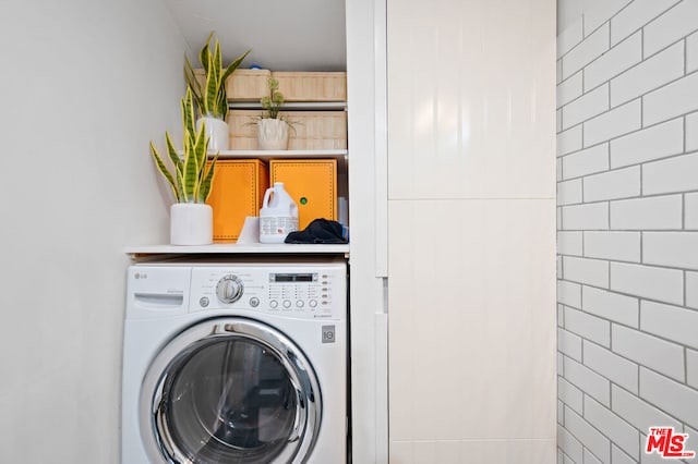 washroom with washer / dryer