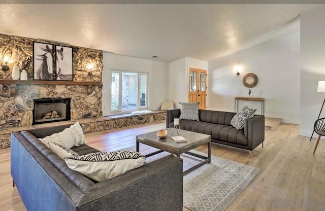 living room with a fireplace and light hardwood / wood-style flooring