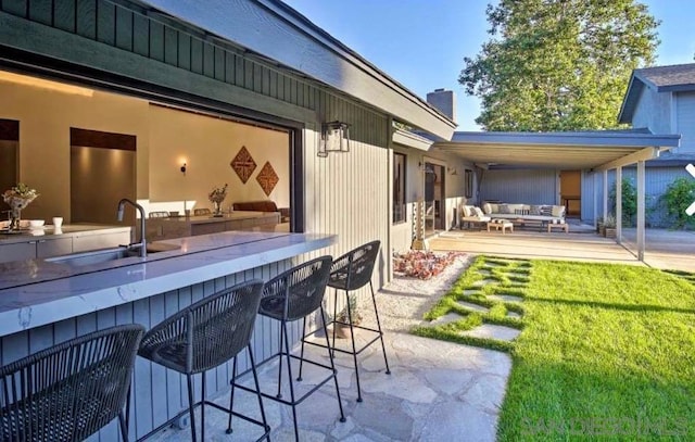 view of patio / terrace with an outdoor wet bar and an outdoor living space