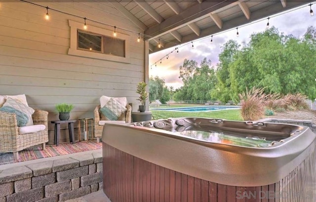 patio terrace at dusk with a hot tub