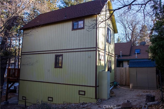 view of side of home with a storage unit