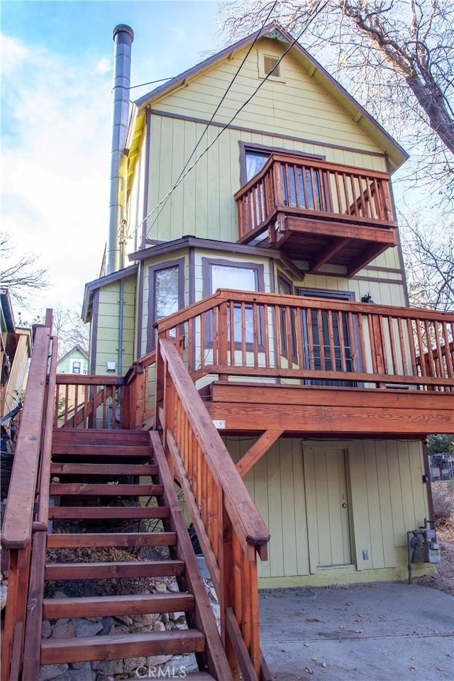 rear view of house with a balcony and a deck