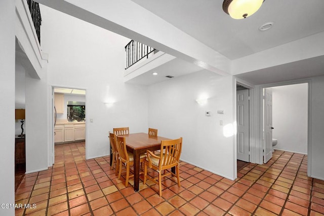 dining space featuring a high ceiling