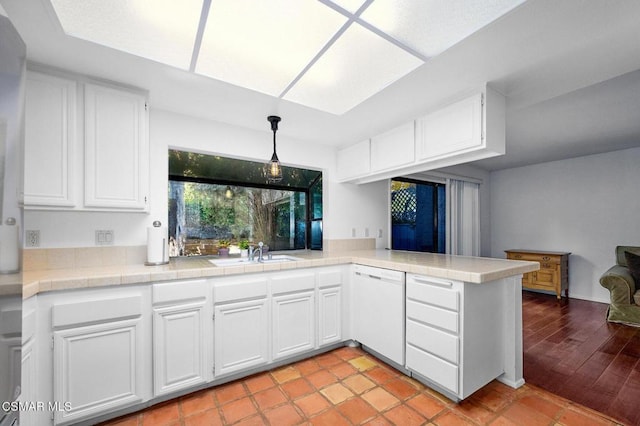 kitchen featuring white cabinetry, dishwasher, and sink