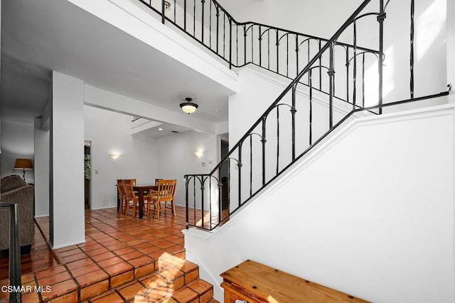 staircase featuring tile patterned floors