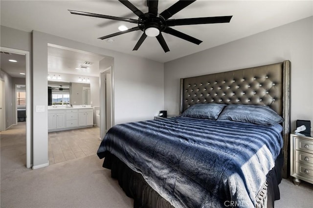 carpeted bedroom featuring ceiling fan and ensuite bathroom