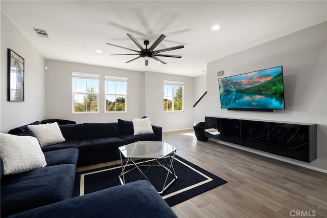 living room with ceiling fan and wood-type flooring