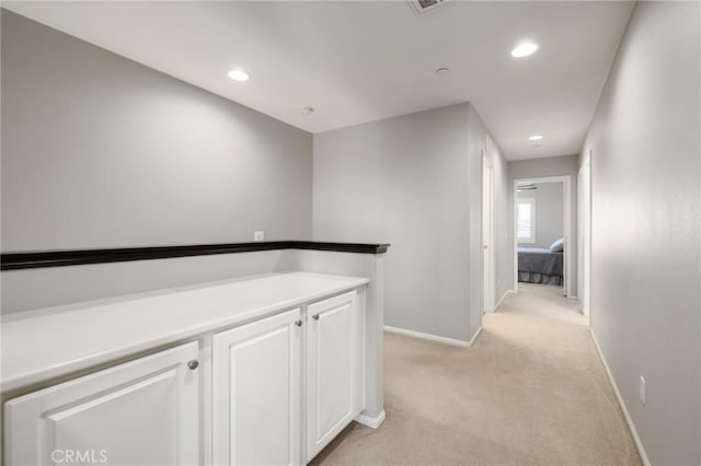 hallway featuring light carpet