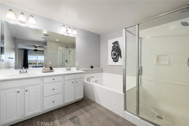 bathroom featuring separate shower and tub and vanity