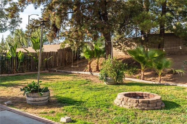 view of yard with an outdoor fire pit