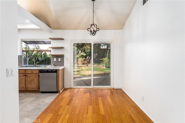 interior space featuring beam ceiling, sink, a chandelier, and light hardwood / wood-style flooring