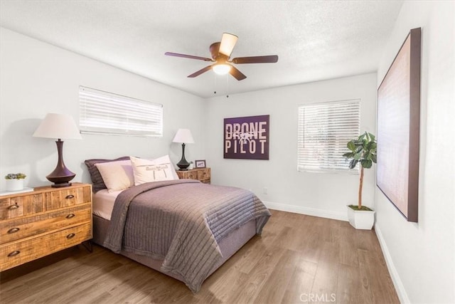 bedroom with ceiling fan and light hardwood / wood-style flooring