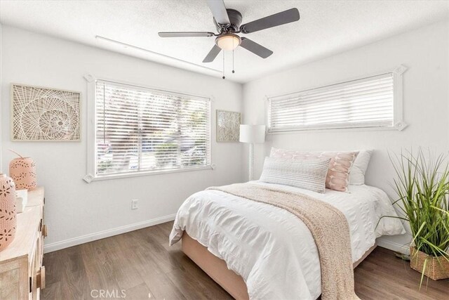 bedroom with ceiling fan and dark wood-type flooring