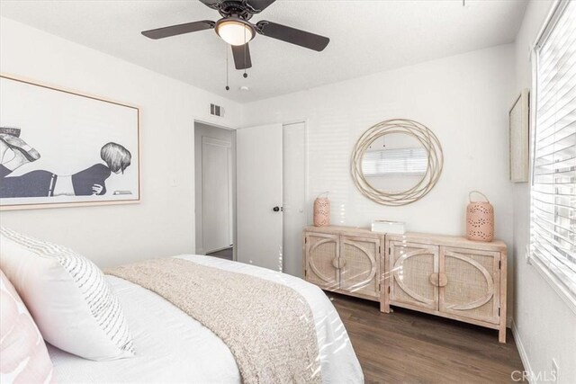 bedroom featuring ceiling fan and dark hardwood / wood-style floors