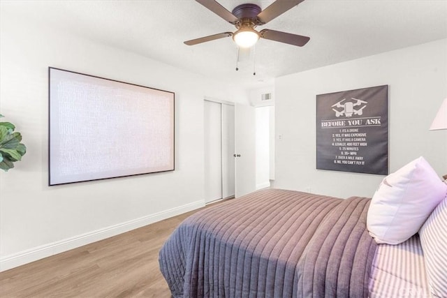 bedroom with ceiling fan and hardwood / wood-style flooring