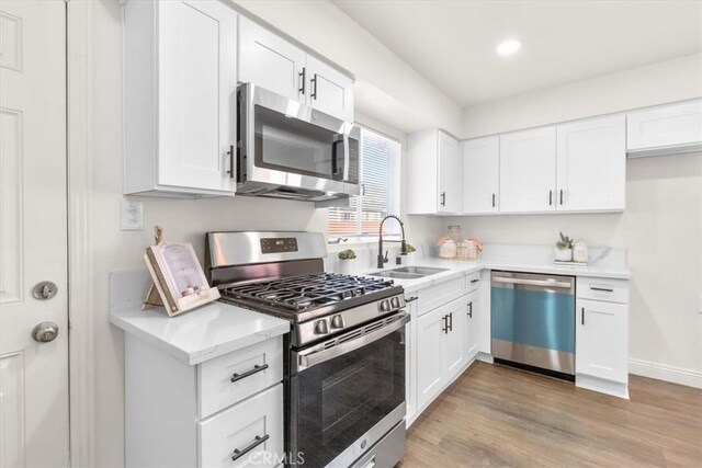 kitchen with white cabinetry and stainless steel appliances