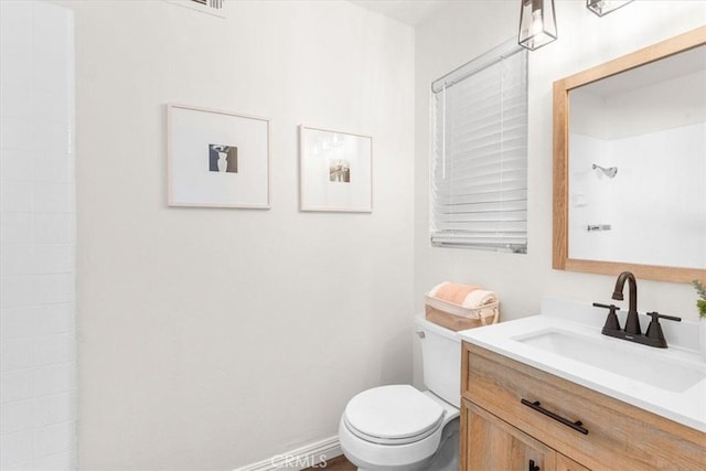 bathroom featuring toilet and vanity