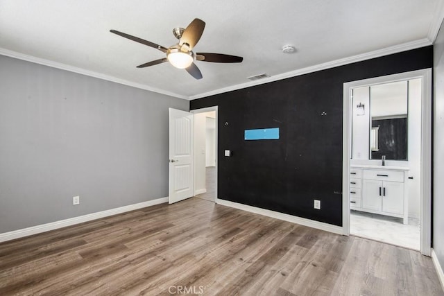 unfurnished bedroom with ceiling fan, ensuite bathroom, crown molding, and hardwood / wood-style floors