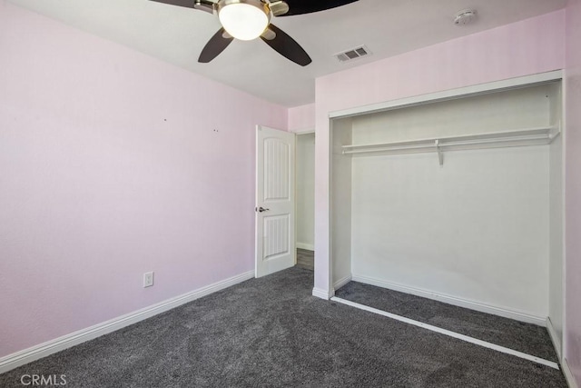 unfurnished bedroom featuring ceiling fan, a closet, and dark colored carpet