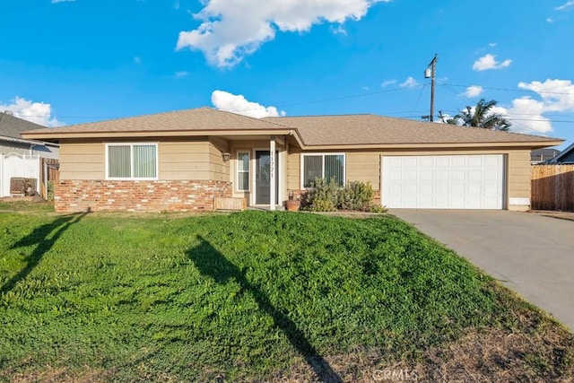 ranch-style house featuring a garage and a front lawn