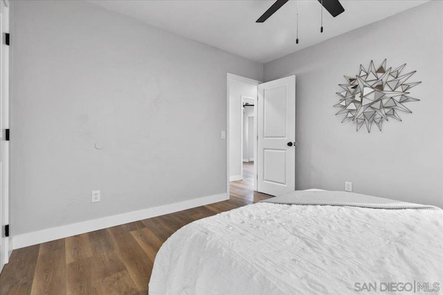 bedroom with ceiling fan and dark hardwood / wood-style flooring