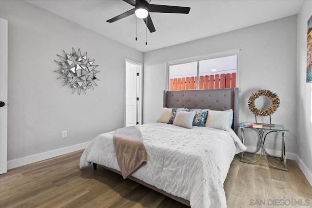 bedroom with ceiling fan and wood-type flooring