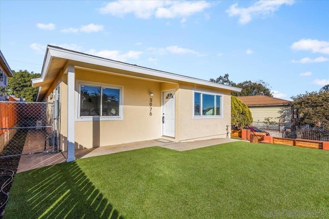 rear view of property with a lawn